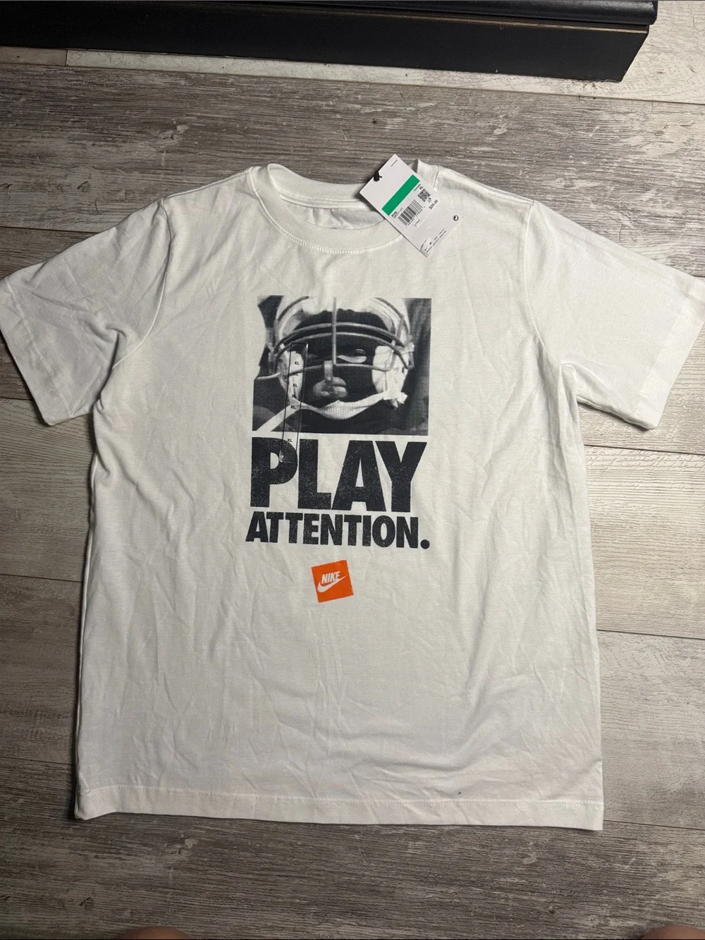 Nike White Graphic 'PLAY ATTENTION' Tee with Black Print and Orange Logo